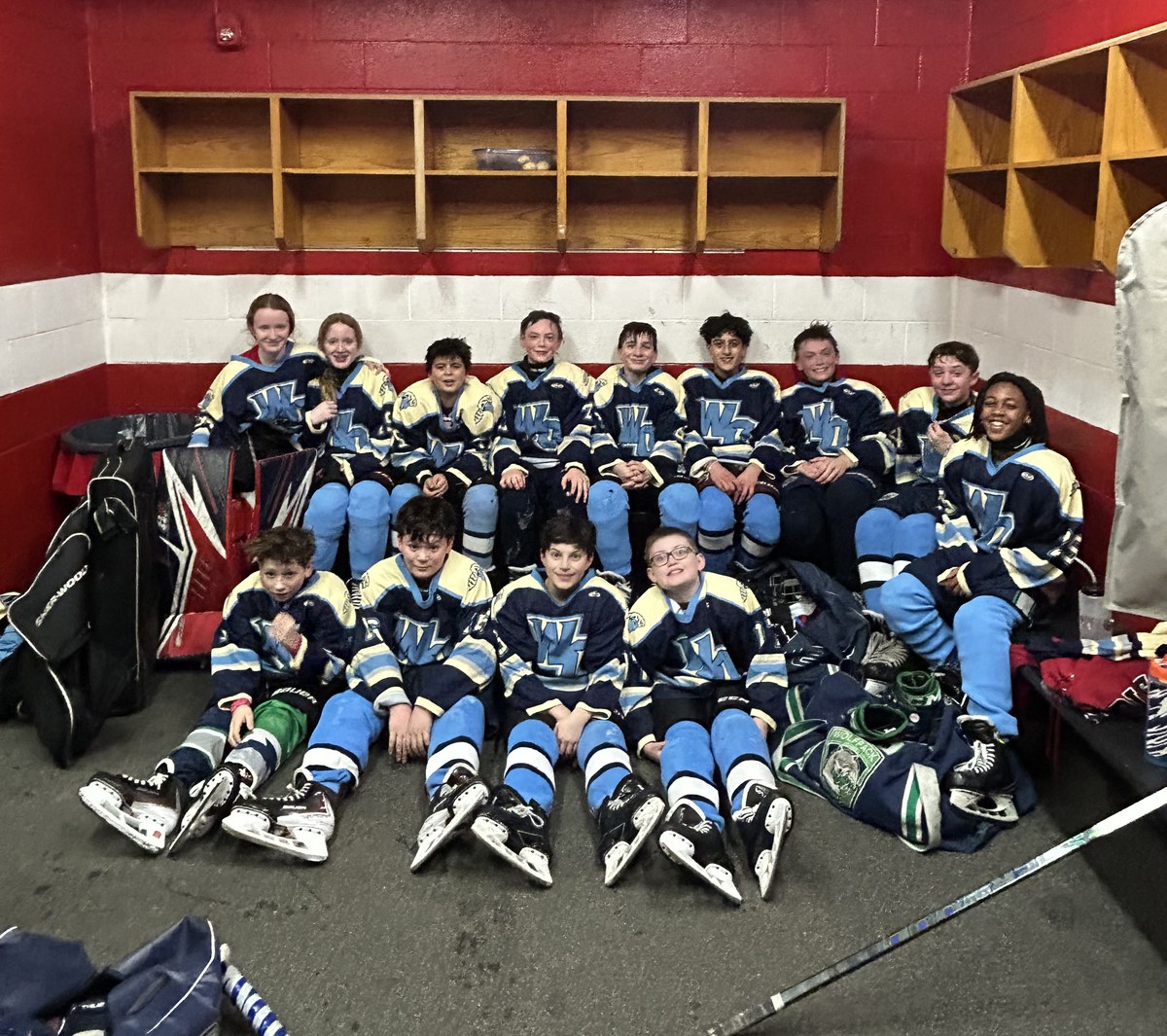 MTL middle school hockey team together in the locker room