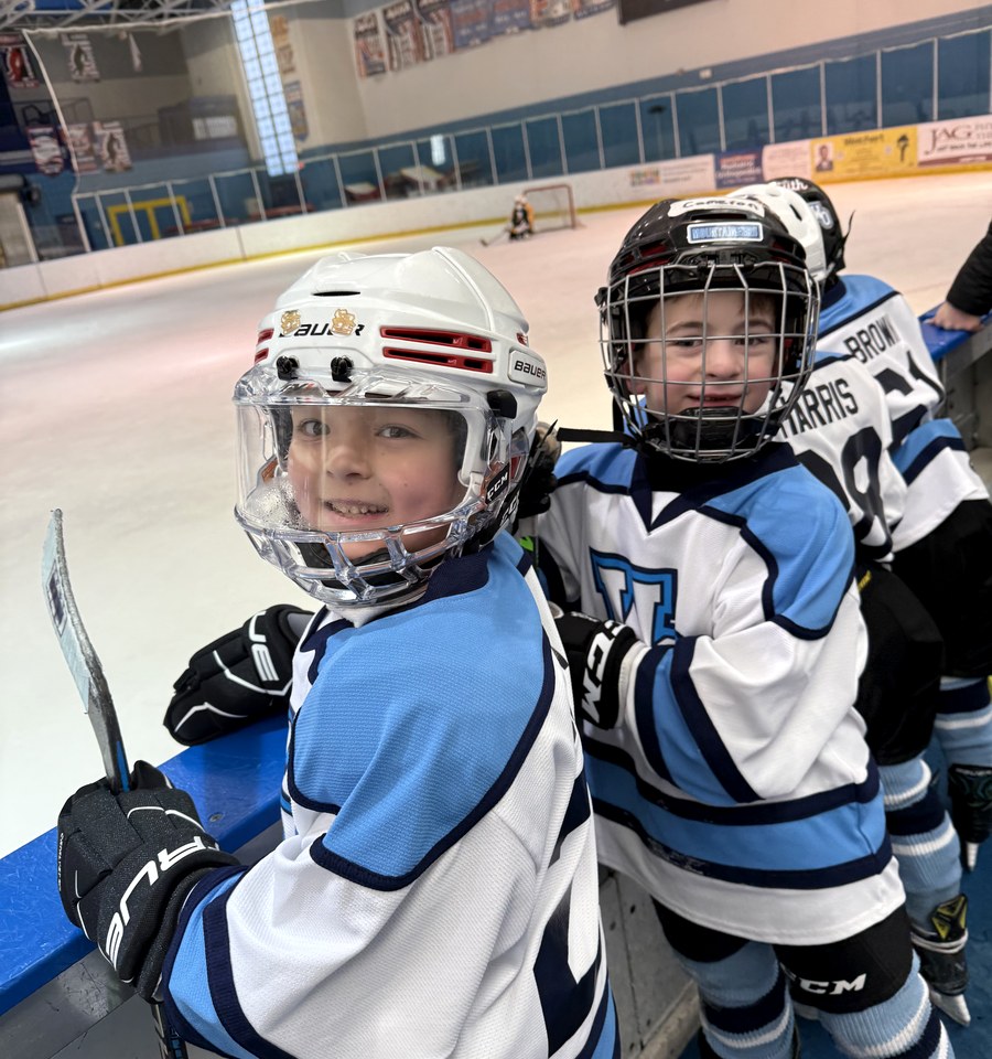 Two smiling MTL Mites players at the boards