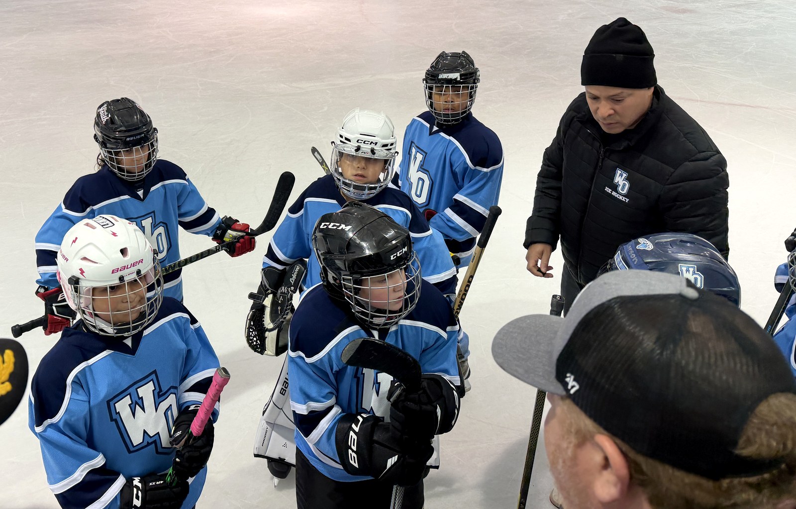 MTL players huddled with their coach on the ice